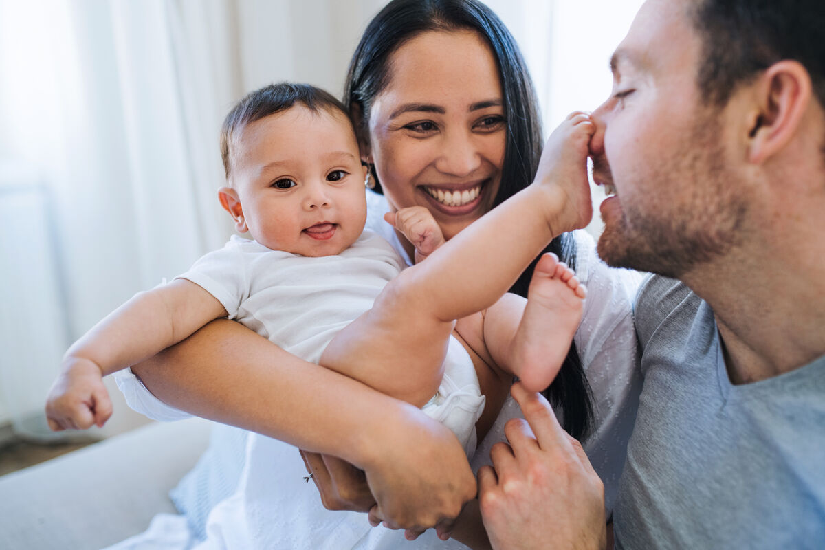 Happy couple expecting a baby, embracing with joy